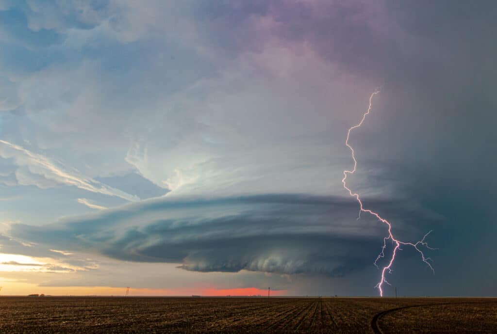 A bolt of lightning strikes ahead of a beautifully sculpted mesocyclone on a storm near Sublette, Kansas on May 21, 2020